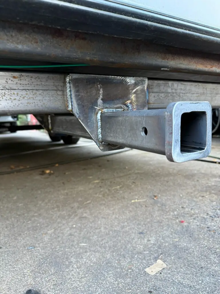 Square receiver hitch Neal welded under a fifth wheel trailer frame